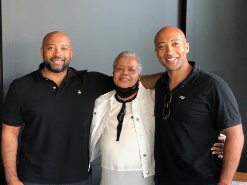 Alford Brothers (left and right) smiling with Val Skeeter (middle)