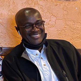 Headshot of Dr. George Kintiba; young man 