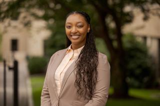Headshot of Dr. Ashley Everson; young women in a tan suit 