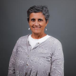 Headshot of Dr. Sangeetha Madhavan; women in a gray shirt.